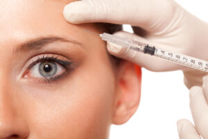 closeup beautiful woman eye, syringe injection beauty concept